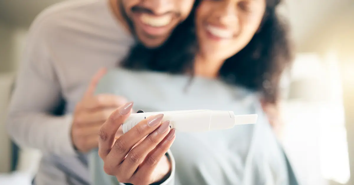 IVF clinic consultation with a doctor speaking to a couple during a fertility evaluation in a bright medical office.