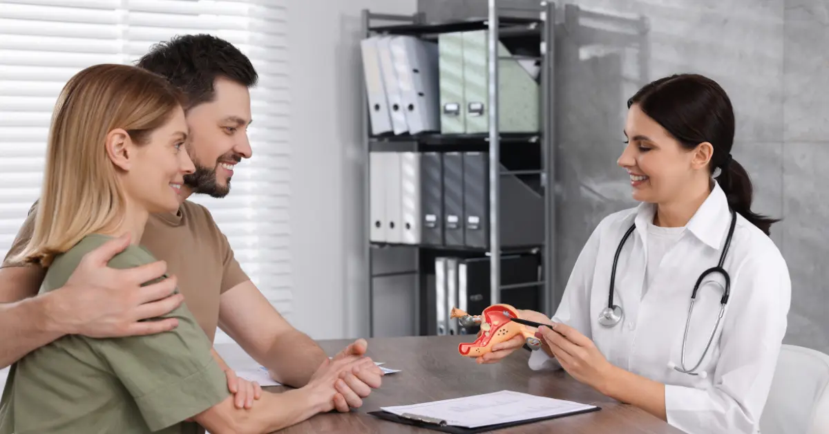 Clomid ovulation induction counseling with a couple meeting a fertility specialist in a modern medical office.