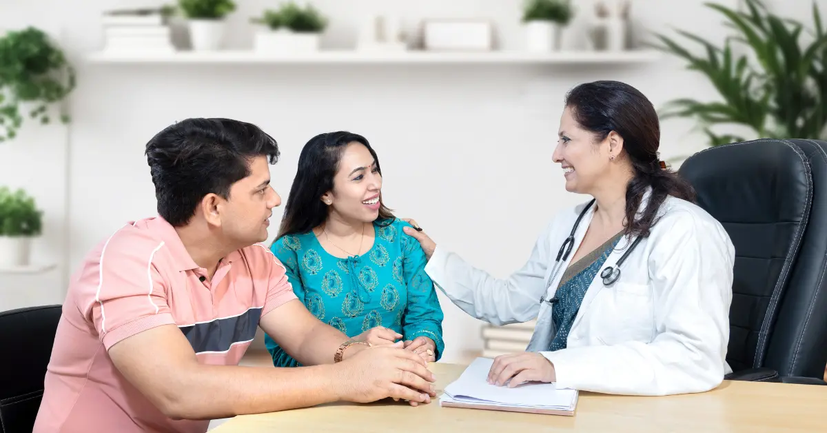 IVF pregnancy chances discussed as a couple smiles during a consultation with a fertility doctor in an office.