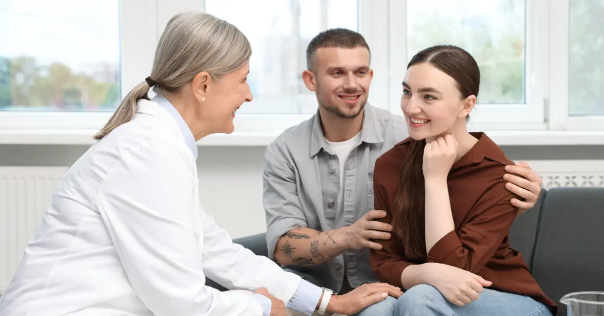 Fertility hormone test consultation with a couple meeting a doctor in a professional clinical setting.