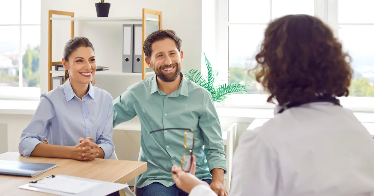 Natural IUI treatment progress monitored during a prenatal ultrasound with a smiling pregnant woman and doctor.