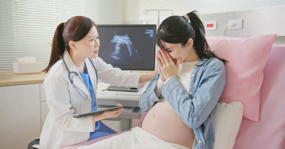 Reproductive health screening scene with a doctor comforting a pregnant patient during an emotional ultrasound visit.